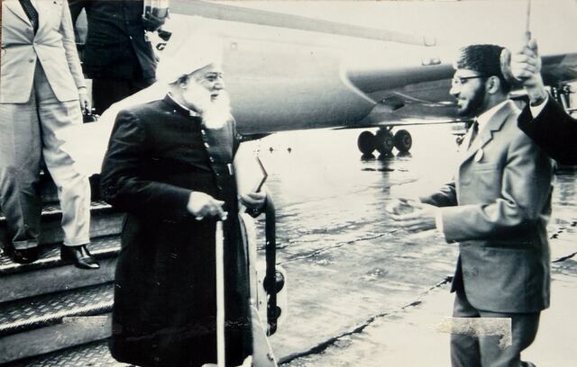 Hazrat Khalifatul Masih III on the airfield, greeted by Maulana Anweri.